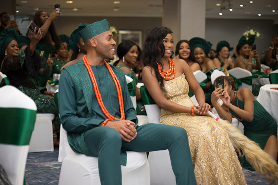 Bride and groom smile as they watch the dancefloor